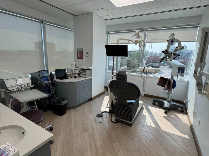 Dental operatory with chair, microscope and window
